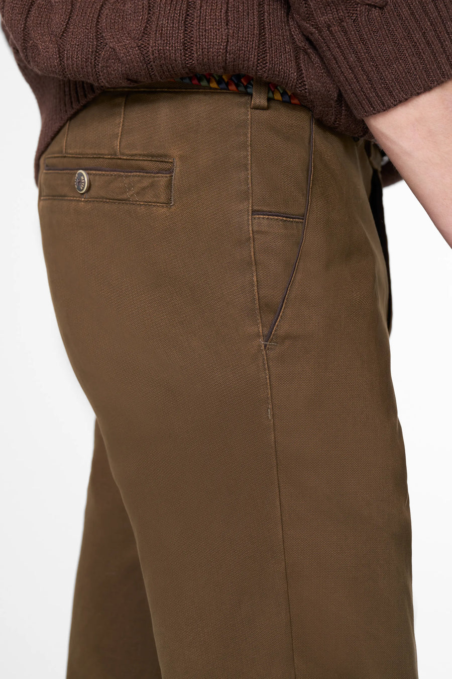 Brown pants worn by a person on a white background